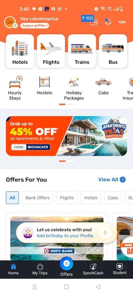 Goibibo travel booking app home screen showing options to book hotels, flights, trains, buses, cabs, hostels, hourly stays, and holiday packages, along with travel deals, offers, and rewards.