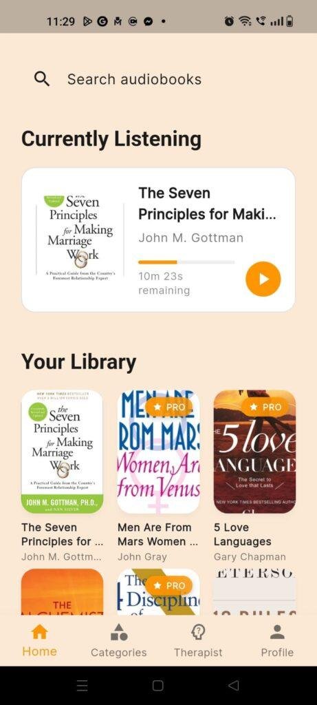 Dhwani Malayalam audiobook app home screen showing the audiobook library, currently playing title, search bar, and audiobook categories.