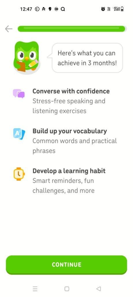 A Duolingo mobile onboarding screen displaying a motivational message from Duo the owl mascot about achievements over a three-month horizon. Below the speech bubble, a clean vertical list outlines core user benefits including 'Converse with confidence', 'Build up your vocabulary', and 'Develop a learning habit' .